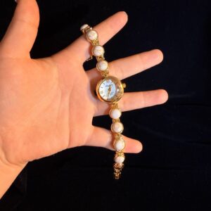 Vintage secondhand ivory and gold retro white marble-patterned bracelet watch, a niche wristwatch.